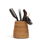 Small tapered woven rattan basket holding dried flowers