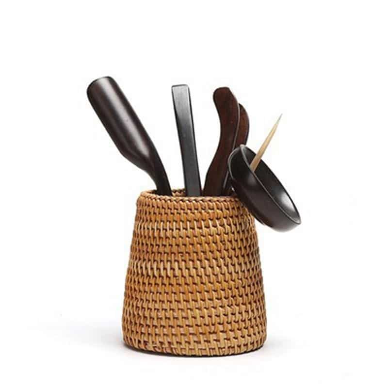 Small tapered woven rattan basket holding dried flowers