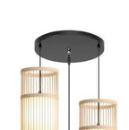Three woven bamboo cylinder shades hanging from a round black canopy