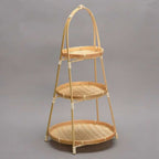 Three tier fruit basket stand with woven trays on a bamboo frame