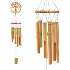 Bamboo wind chime with a carved tree of life medallion above the tubes