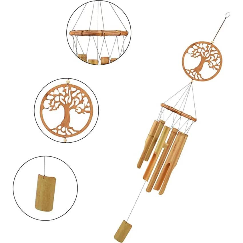 Bamboo wind chime with a carved tree of life medallion above the tubes