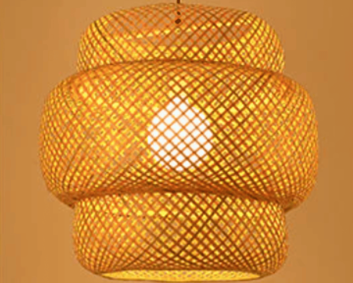 Two tier woven rattan lantern pendant glowing warm