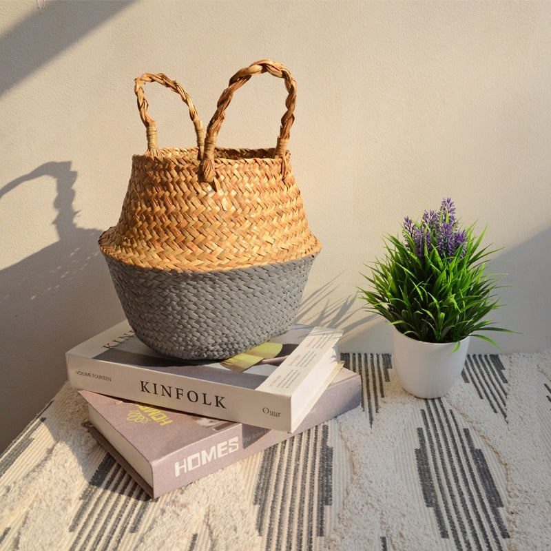 Two tone woven belly basket with green base holding white flowers