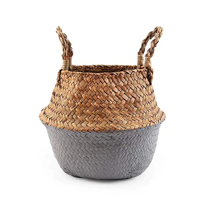 Two tone woven belly basket with green base holding white flowers
