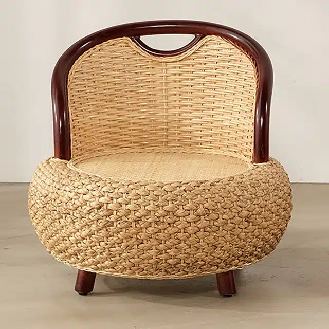 Compact low armchair with rounded shapes, hand woven in two tone beige and brown rattan