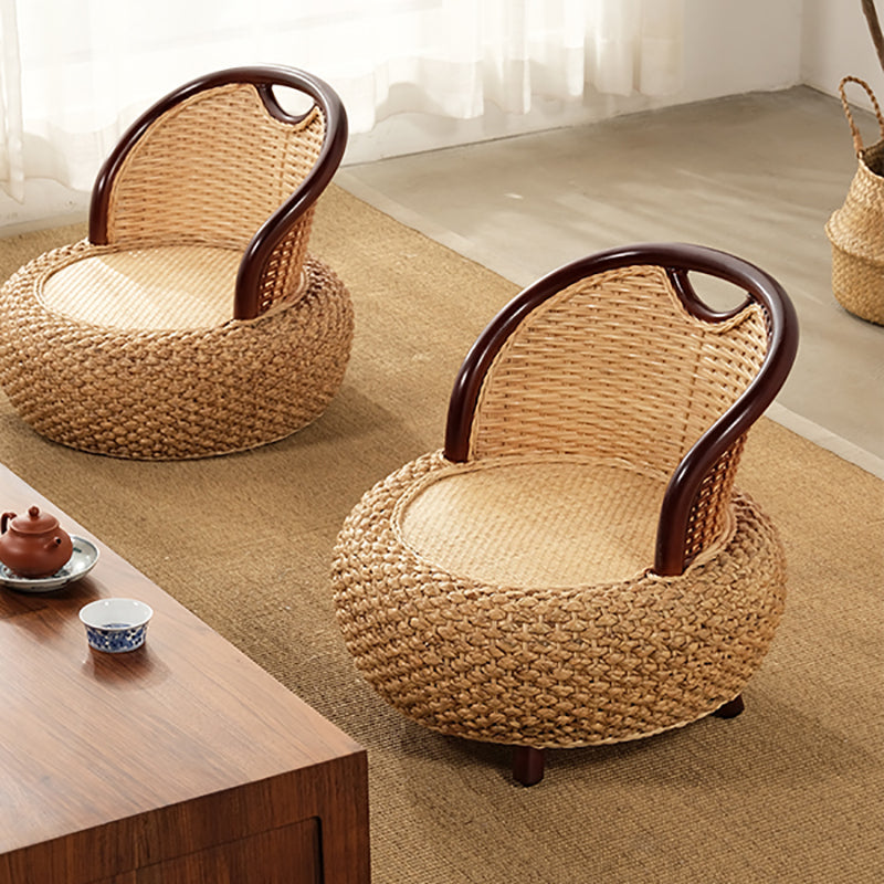 Compact low armchair with rounded shapes, hand woven in two tone beige and brown rattan