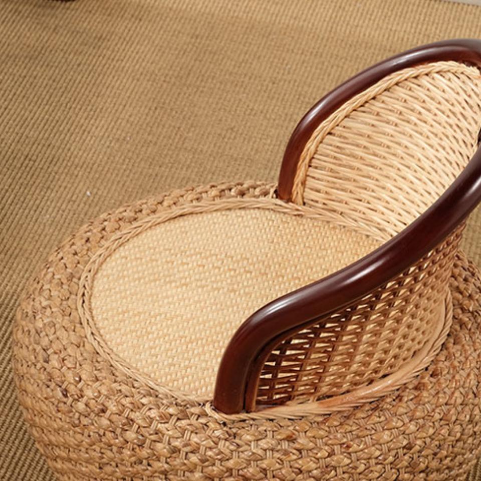 Compact low armchair with rounded shapes, hand woven in two tone beige and brown rattan