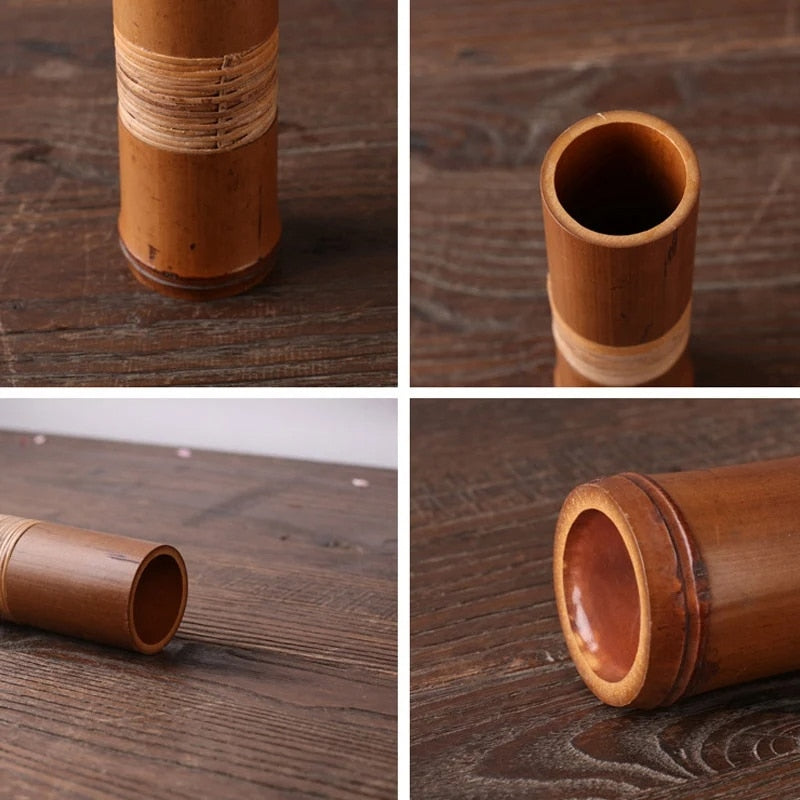 Brown bamboo tube vase with a woven band around the middle