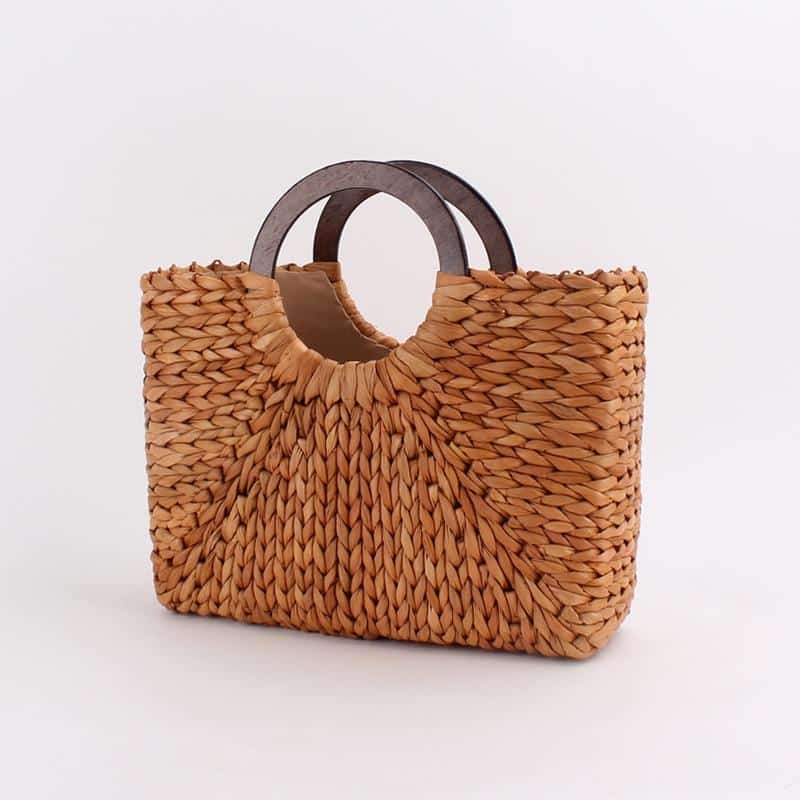 Vintage caramel brown hand woven rattan bag with round varnished wooden handles