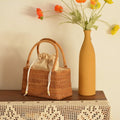 Honey rattan handbag with top handles and drawstring liner