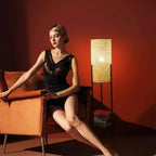 Vintage floor lamp with a hand woven rattan shade on a black iron tripod