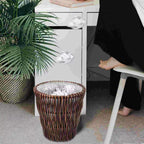 Round brown rattan wastebasket with a vintage woven pattern