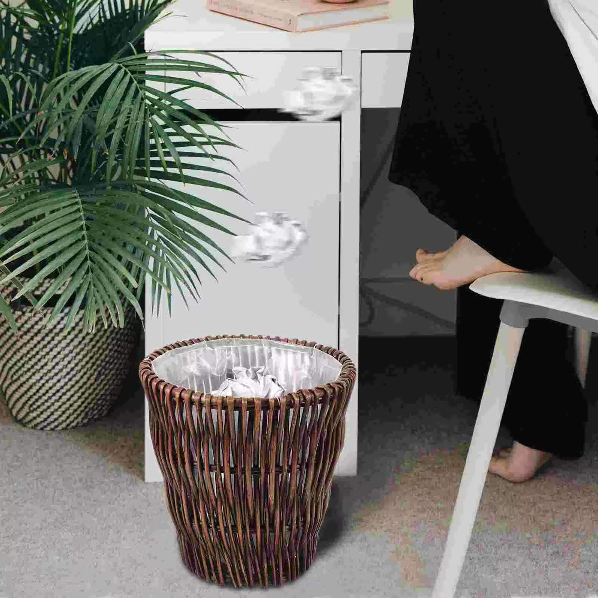 Round brown rattan wastebasket with a vintage woven pattern