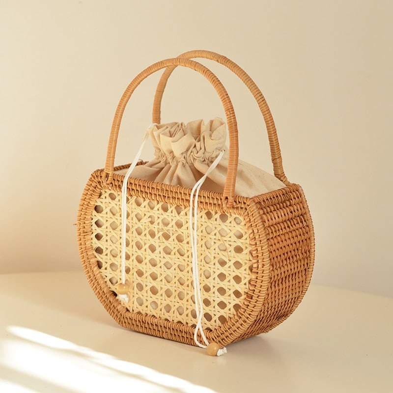 Compact round vintage hand woven rattan handbag with a rattan top handle