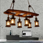 Vintage pendant light with a natural wood branch and six glass and metal lanterns