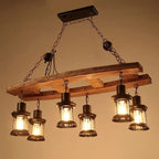 Vintage pendant light with a natural wood branch and six glass and metal lanterns