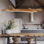 Long linear chandelier in wood look resin with an amber tone