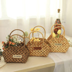 Three vintage woven flower baskets with handles and flowers