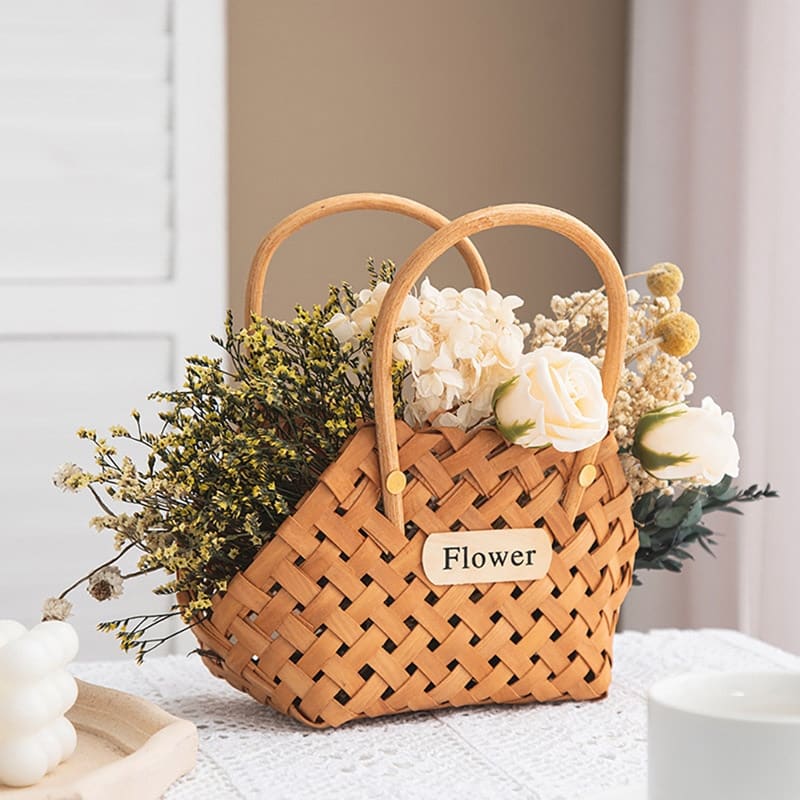 Three vintage woven flower baskets with handles and flowers