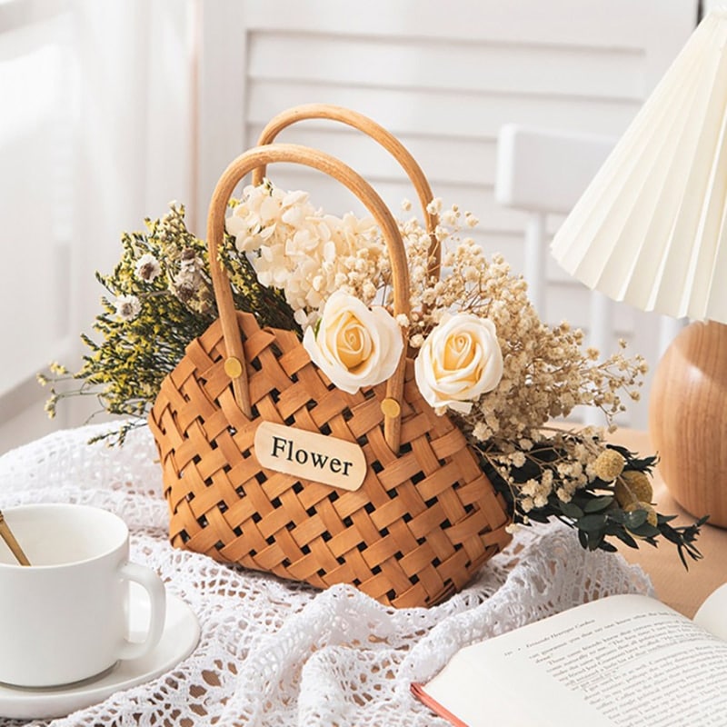 Three vintage woven flower baskets with handles and flowers