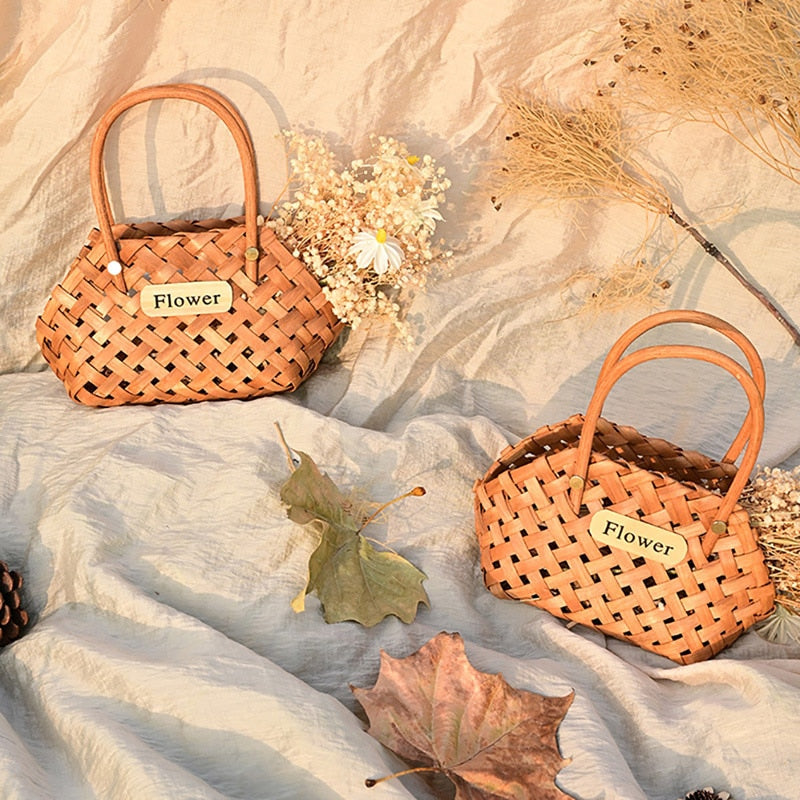 Three vintage woven flower baskets with handles and flowers