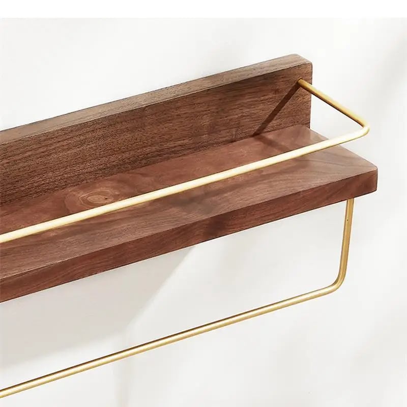 Walnut tone wood bathroom shelf with gold towel bar