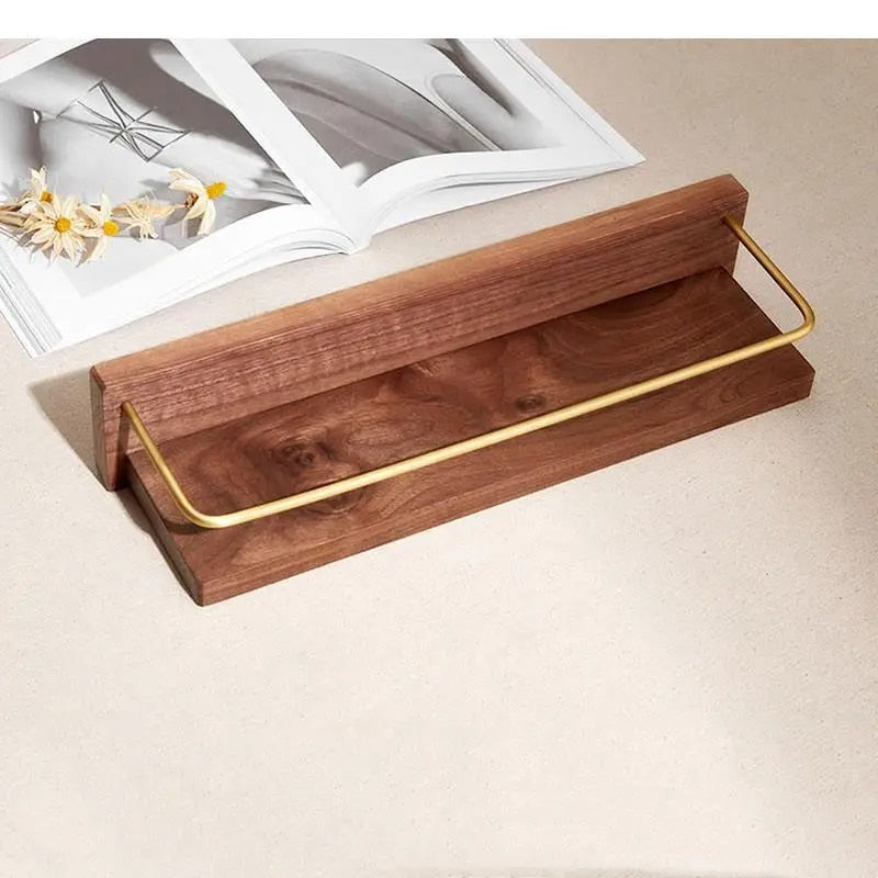 Walnut tone wood bathroom shelf with gold towel bar