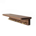 Walnut tone wood shelf with four brass key hooks