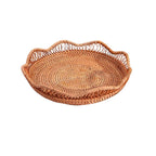 Shallow round brown rattan fruit basket with wavy rim