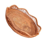 Shallow round brown rattan fruit basket with wavy rim