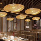 Round chandelier with softly wavy rings hand woven in natural rattan