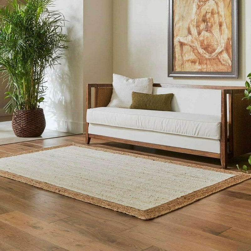 White jute rug with a natural braided border in a living room