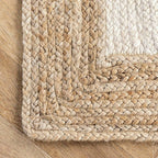 White jute rug with a natural braided border in a living room