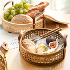 Round white rattan storage tray with stitched leather handles