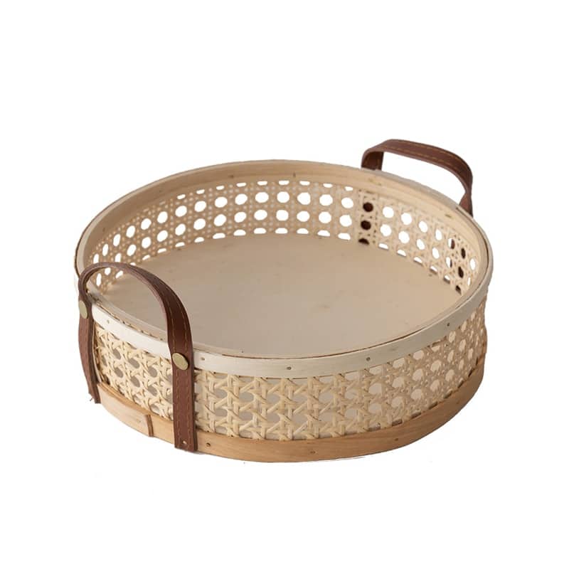 Round white rattan storage tray with stitched leather handles