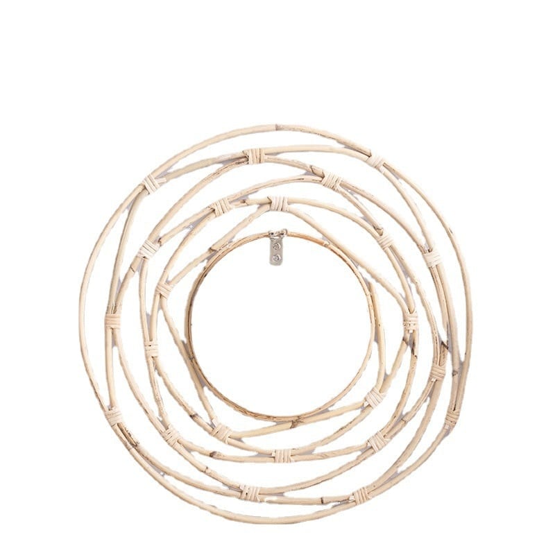 Round mirror framed by white rattan swirling loops