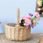 Round white wicker basket with tall handle holding pine cones
