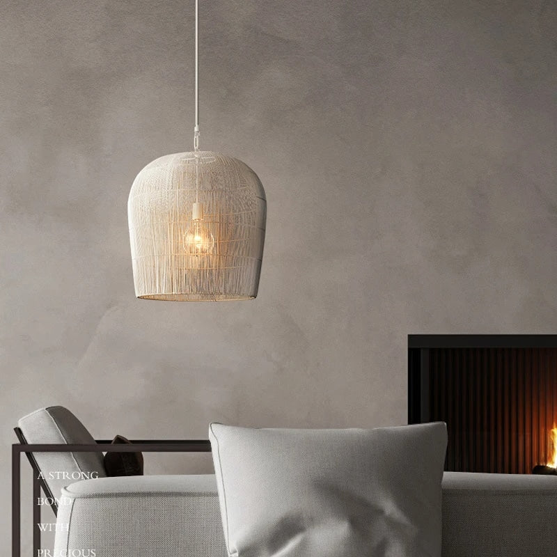 Small white woven rattan bell pendant in a living room