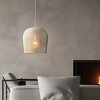 Small white woven rattan bell pendant in a living room