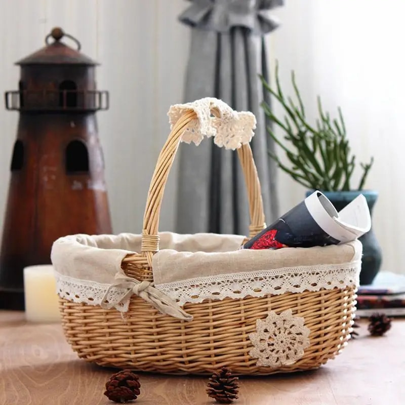 Oval wicker basket with lace trimmed liner and handle