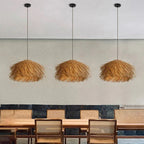 Three natural wicker fringe pendants over a dining table