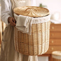 Round wicker laundry hamper with woven lid and lace trimmed liner