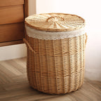 Round wicker laundry hamper with woven lid and lace trimmed liner