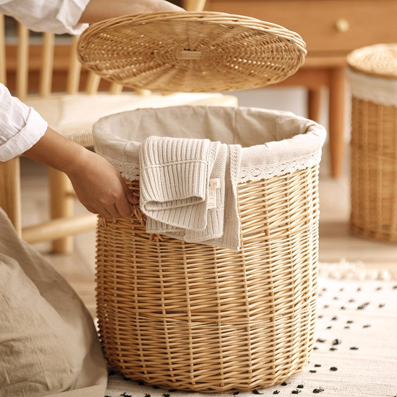 Round wicker laundry hamper with woven lid and lace trimmed liner