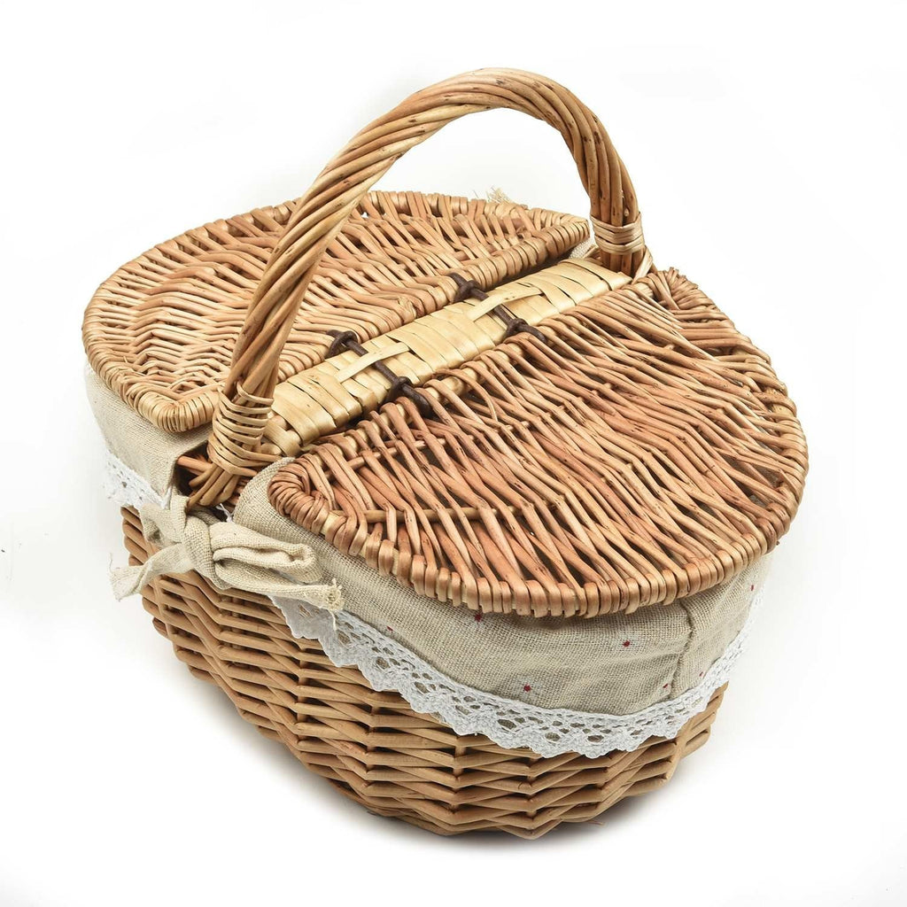 Oval wicker basket with flip lid and lace liner on a garden bench