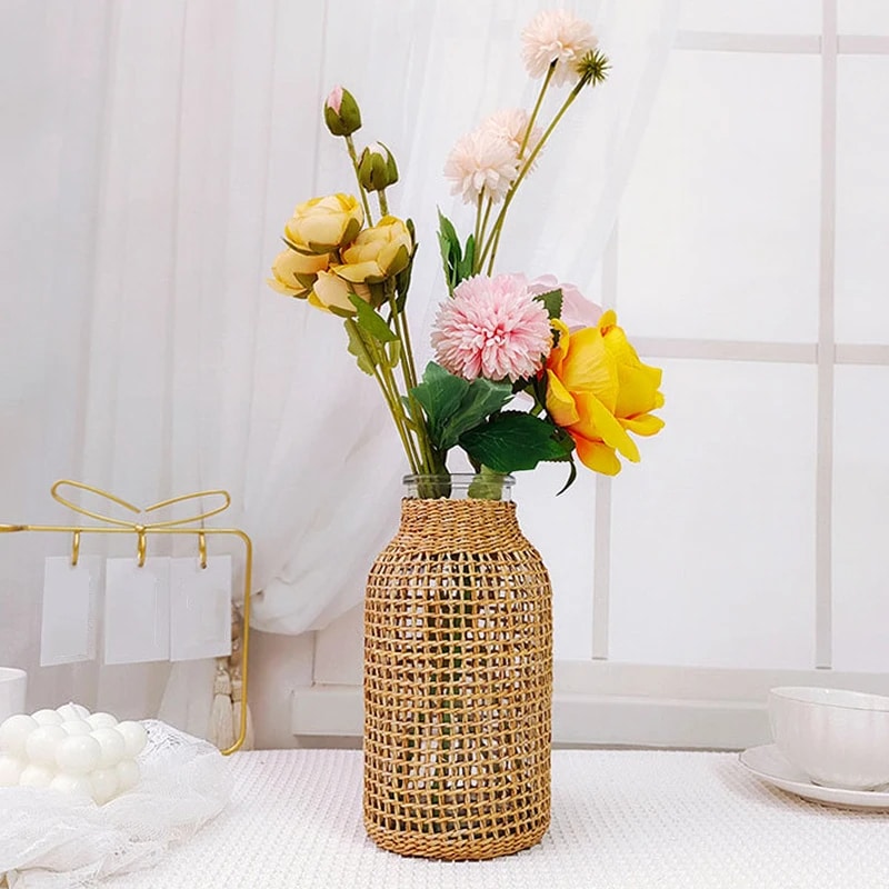 Wicker wrapped glass vase holding fresh flowers