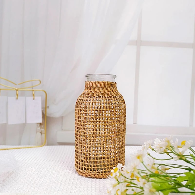 Wicker wrapped glass vase holding fresh flowers