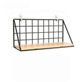 Black wire wall shelf with a light wood base