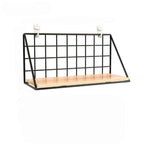 Black wire wall shelf with a light wood base